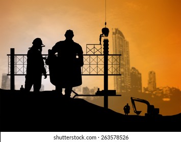 silhouette man engineer looking blueprint in a building site over Blurred construction worker on construction site - Shutterstock ID 263578526