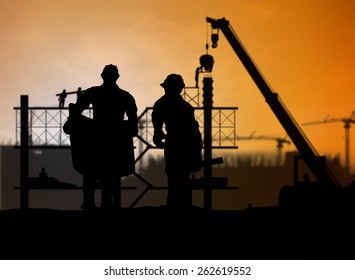 silhouette man engineer looking construction worker in a building site over Blurred construction site - Shutterstock ID 262619552