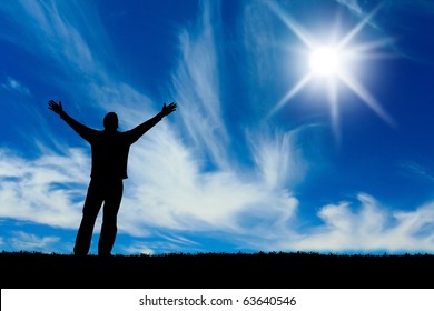 Silhouette of man with hands raised to a bright star in the sky.