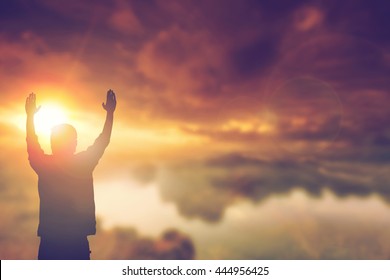 Silhouette man with hands rise up on beautiful view. Christian praise on hill thanksgiving day background. Now one man standing on peak open arms enjoying nature the sun concept world wisdom fun hope