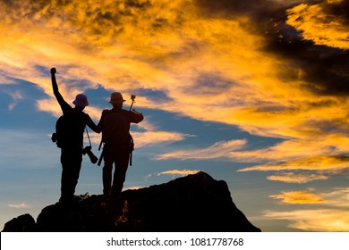 Silhouette of man hold up hands on the peak of mountain,success concept

 - Shutterstock ID 1081778768