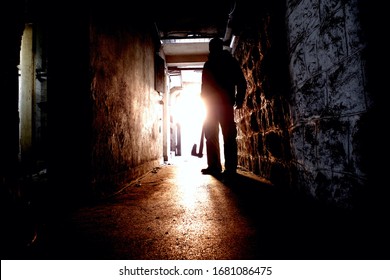 Silhouette Of Man Holding Axe. Hatchet In Arm In Dark Hallway. Scary Homicide Scenes