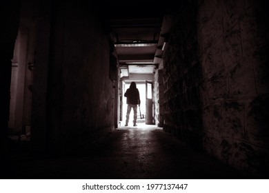 Silhouette Of Man Holding Axe. Hatchet In Arm In Dark Hallway. Scary Homicide Scenes