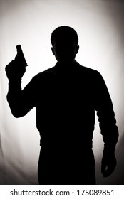 Silhouette Of A Man Holding A Gun