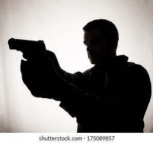 Silhouette Of A Man Holding A Gun