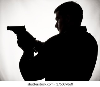 Silhouette Of A Man Holding A Gun