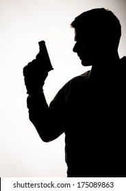 Silhouette Of A Man Holding A Gun