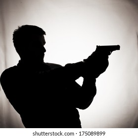 Silhouette Of A Man Holding A Gun