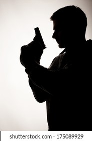 Silhouette Of A Man Holding A Gun