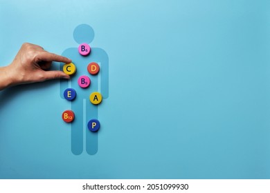 A silhouette of a man with an image of vitamins on it. A symbol of the need for vitamins for the body - Shutterstock ID 2051099930