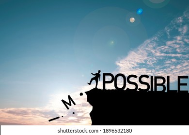 Silhouette Man Kicking Alphabet From Cliff To Change Impossible To Possible With Cloud Blue Sky , Positive Mindset Concept.