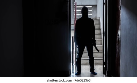 Silhouette Of A Man With Knife In The Apartment, Murder Concept, Concept Of Disaster