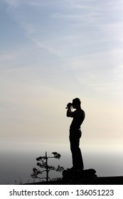 Silhouette of a man lookout over ocean