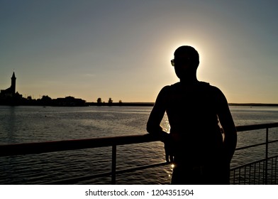 silhouette of a man near the river                      