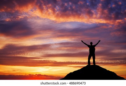 Silhouette of a man on a mountain top. Sport and active life concept - Shutterstock ID 488690473