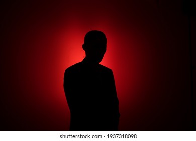 Silhouette of a man on a red background. - Powered by Shutterstock