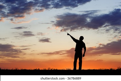 Silhouette Of Man Pointing During Dawn Or Evening