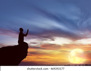 Silhouette Of Man Praying At Sunset. He Pray To God.