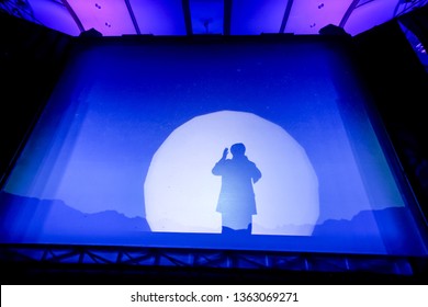 Silhouette Of A Man Preaching In The Stage