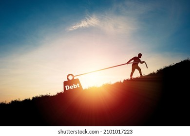 Silhouette Of Man Pulling Debt Weight Box For Debt And Financial Freedom Concept.