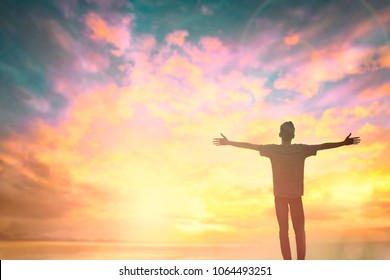 Silhouette of man with raised hands over blur cross concept for religion, worship, prayer and praise. Traveler man in summer high season. - Shutterstock ID 1064493251