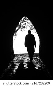 Silhouette Of A Man Reaching The End Fo The Tunnel, Waikawau Beach, New Zealand.