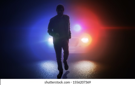 Silhouette of man running away from police car at night.