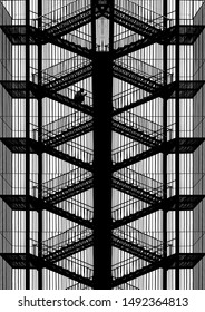 Silhouette Of Man Sitting On Fire Escape