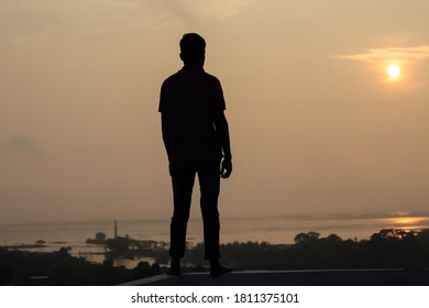 silhouette of a man standing on the roof - Shutterstock ID 1811375101