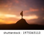 silhouette of man standing on top of mountain at sunset.Travel Lifestyle, success,winner, leader concept, spiritual relaxation and emotional concept, vacations outdoor harmony with nature landscape.