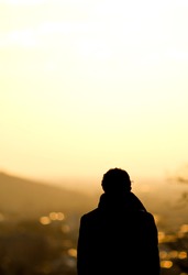Silhouette Of Man Standing Over Freiburg In Sunset