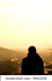 Silhouette Of Man Standing Over Freiburg In Sunset