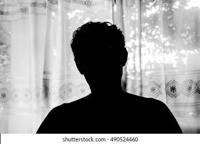 Silhouette man standing in room,Danger in dark