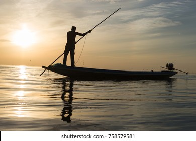 Silhouette of man with sunrise sky background, livelihoods of fishermen in Thailand - Shutterstock ID 758579581