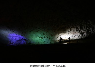 A Silhouette Of A Man Taking A Picture Of His Family In The Cave With Beautiful Lighting - October 22, 2017, Ha Long Bay, Vietnam