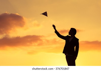 Silhouette Man Throwing Paper Plane