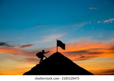 Silhouette of man traveling through mountain ridge to submit destination point for picking up flag. Office worker climbing up cliffs. Concept of business, goal, achievement, career and journey. - Shutterstock ID 2185120475