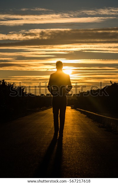Silhouette Man Walking On Road Sunset Stock Photo (Edit Now) 567217618 Silhouette Man Walking Tunnel