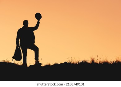 a silhouette of man who raises hat in his hand as sign of farewell. man waving hat goodbye