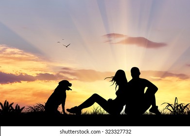Silhouette Of Man And Woman Sitting With A Dog Admiring The Sunset