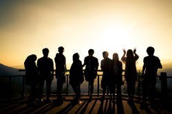 Silhouette Of Many Friends Watching Sun Rise With Hand Posts. To Represent The Meaning Of Joyful And Friend Relationship.