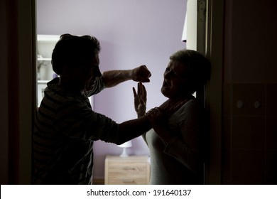 Silhouette of mature couple fighting, the man is physically abusing woman. Woman is victim of domestic violence - Shutterstock ID 191640137