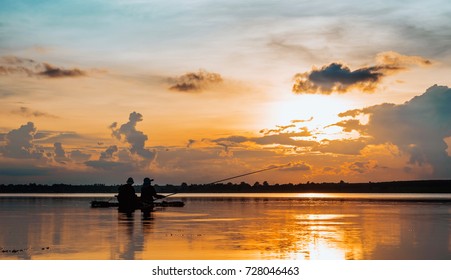 Silhouette Mature Couple Fishing Over Lake In Sunset 