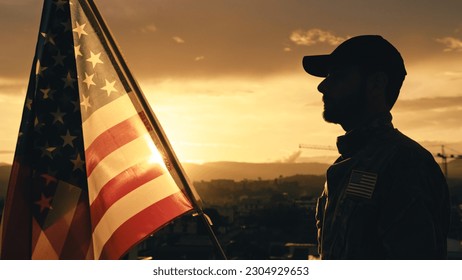 Silhouette of Military Salute of soldier for memorial day against flag at sunset - Powered by Shutterstock