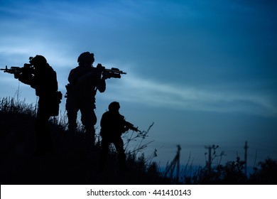 Silhouette Of Military Soldier Or Officer With Weapons At Night. Shot, Holding Gun, Blue Colorful Sky, Background