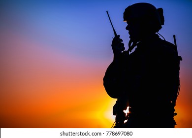 Silhouette Of Military Soldier With Weapons At Sunset. Shot, Holding Gun, Colorful Sky. Military Concept.
