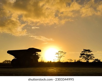 Silhouette of a mining truck crossing the hauling road at sunset in the dusk - Shutterstock ID 2303344995