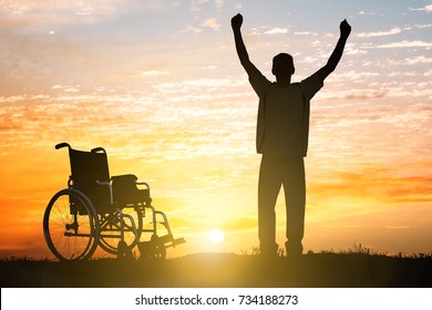 Silhouette Of Miracle Handicapped Man Walking Again At Sunset