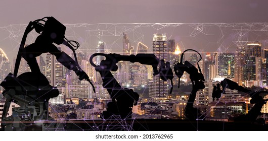 Silhouette Of Modern Automation Robot Arms With Ai Assistant Technology Network Concept And Metropolis City Building Background.