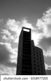 Silhouette Of Modern Comercial Building Against Cloudy Sky